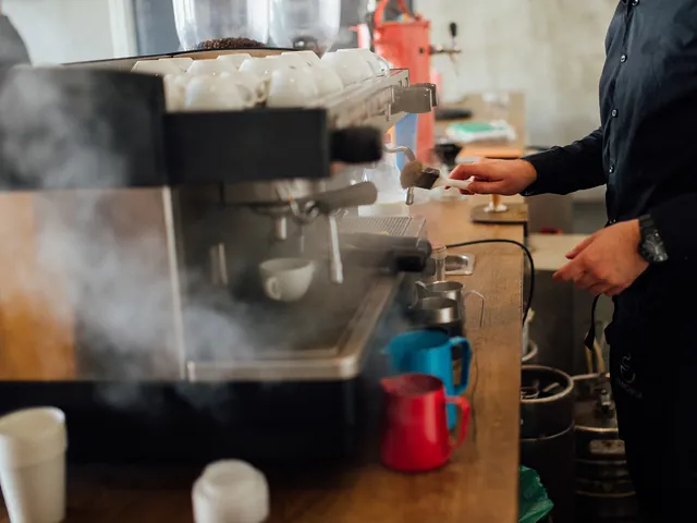 A barista making coffee at an espresso machine